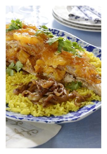 Whole roasted fish with orange and cinnamon on yellow rice with caramelised onions